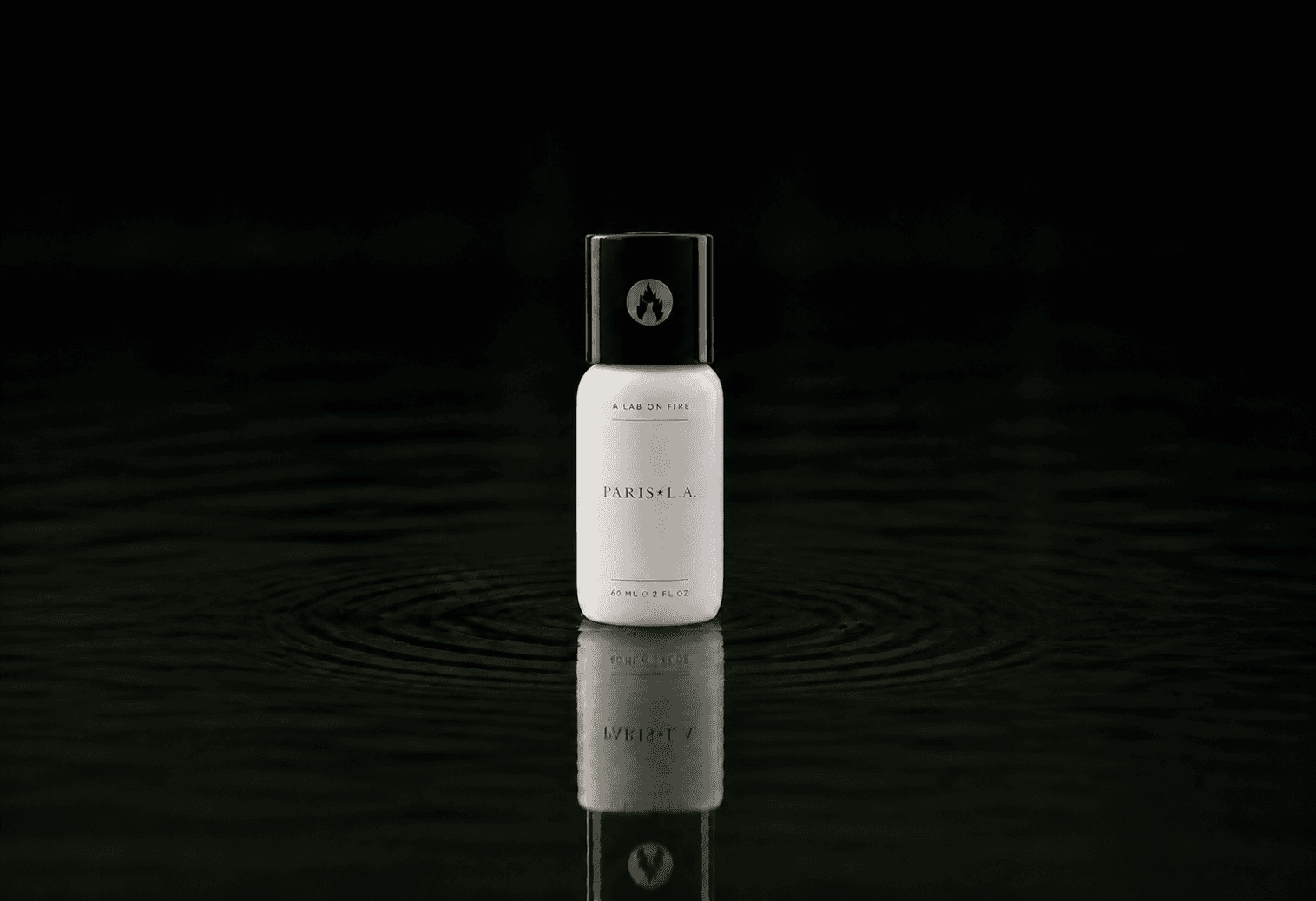 A Lab On Fire Paris*LA fragrance bottle floating above dark water