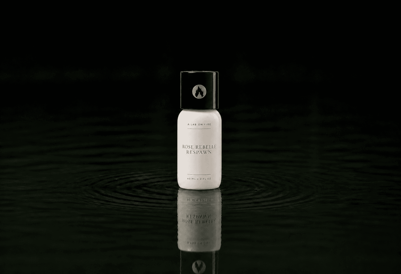 A Lab On Fire Rose Rebelle Respawn fragrance bottle floating above dark water
