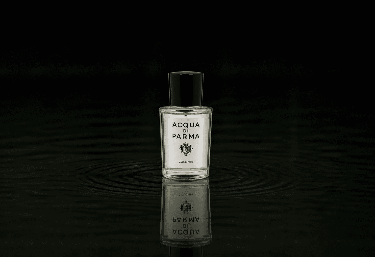 Acqua Di Parma Colonia fragrance bottle floating above dark water