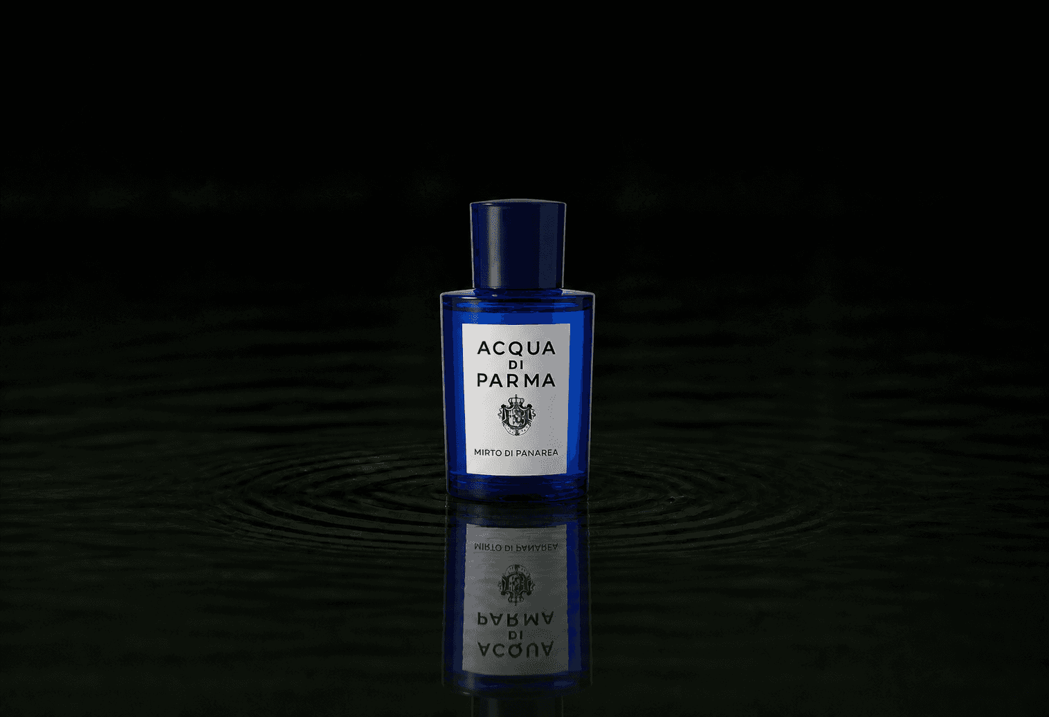 Acqua Di Parma MIRTO fragrance bottle floating above dark water