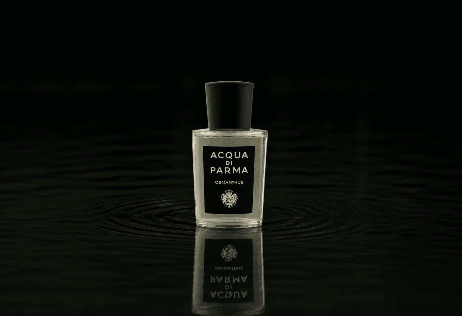 Acqua Di Parma Osmanthus fragrance bottle floating above dark water