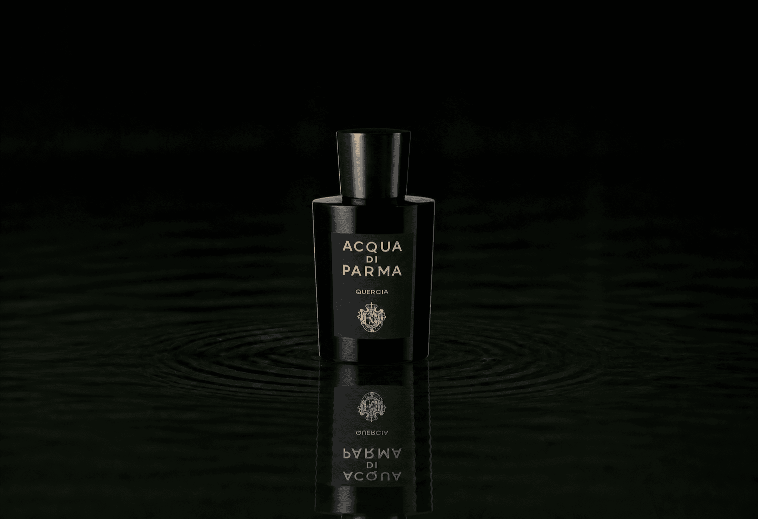 Acqua Di Parma Quercia fragrance bottle floating above dark water