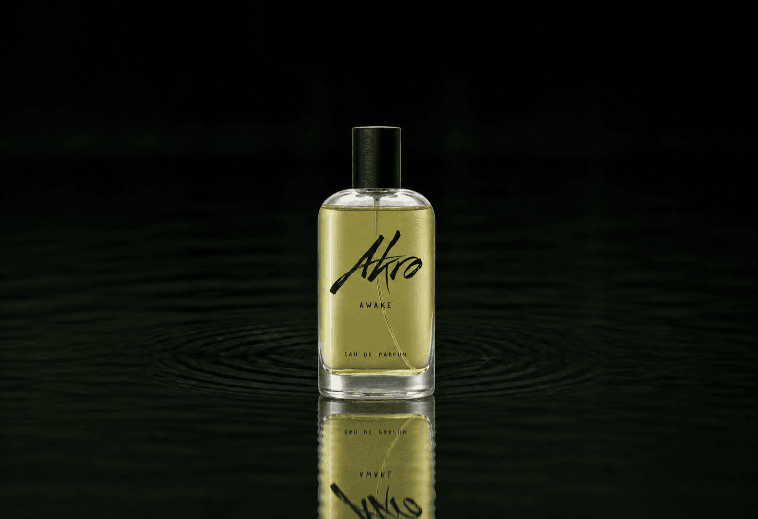 Akro Awake fragrance bottle floating above dark water