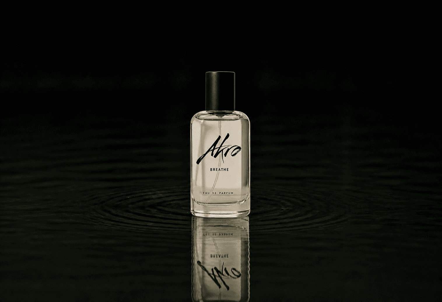 Akro Breathe fragrance bottle floating above dark water