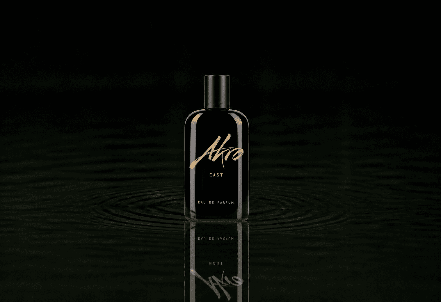 Akro East fragrance bottle floating above dark water