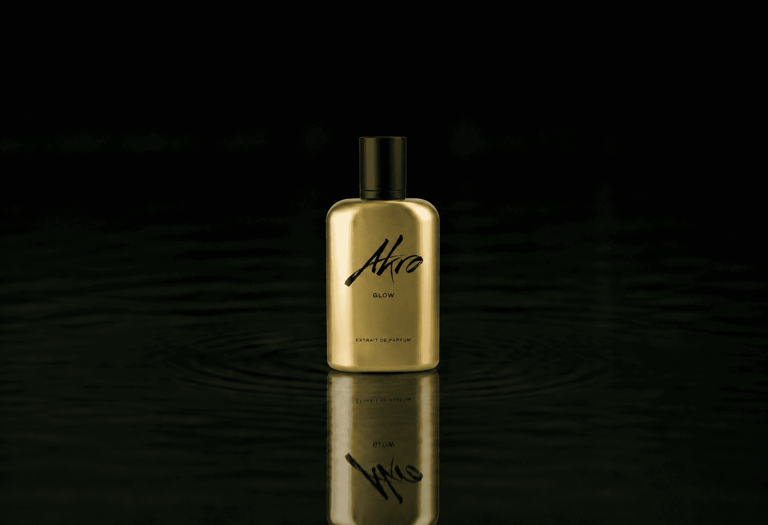 Akro Glow fragrance bottle floating above dark water
