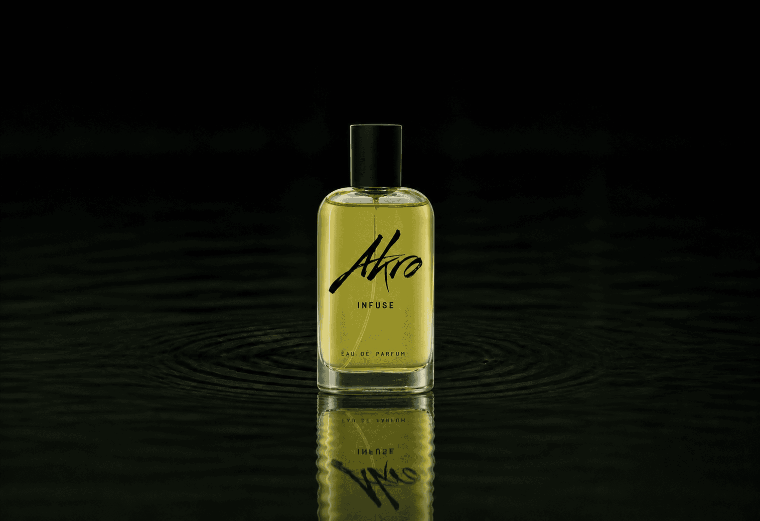 Akro Infuse fragrance bottle floating above dark water