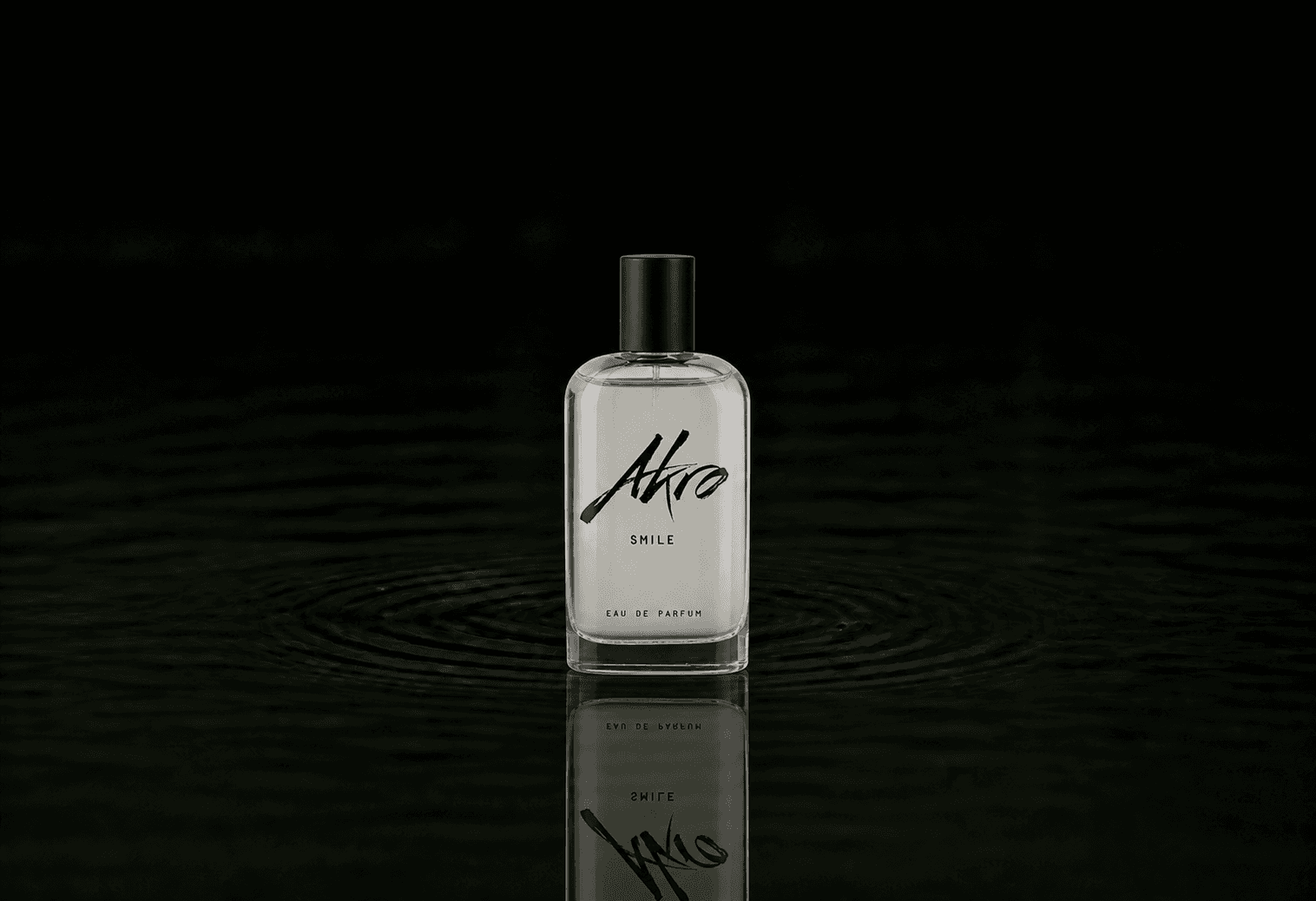 Akro Smile fragrance bottle floating above dark water