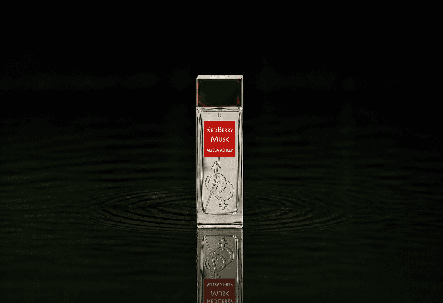 Alyssa Ashley Red Berry Musk fragrance bottle floating above dark water
