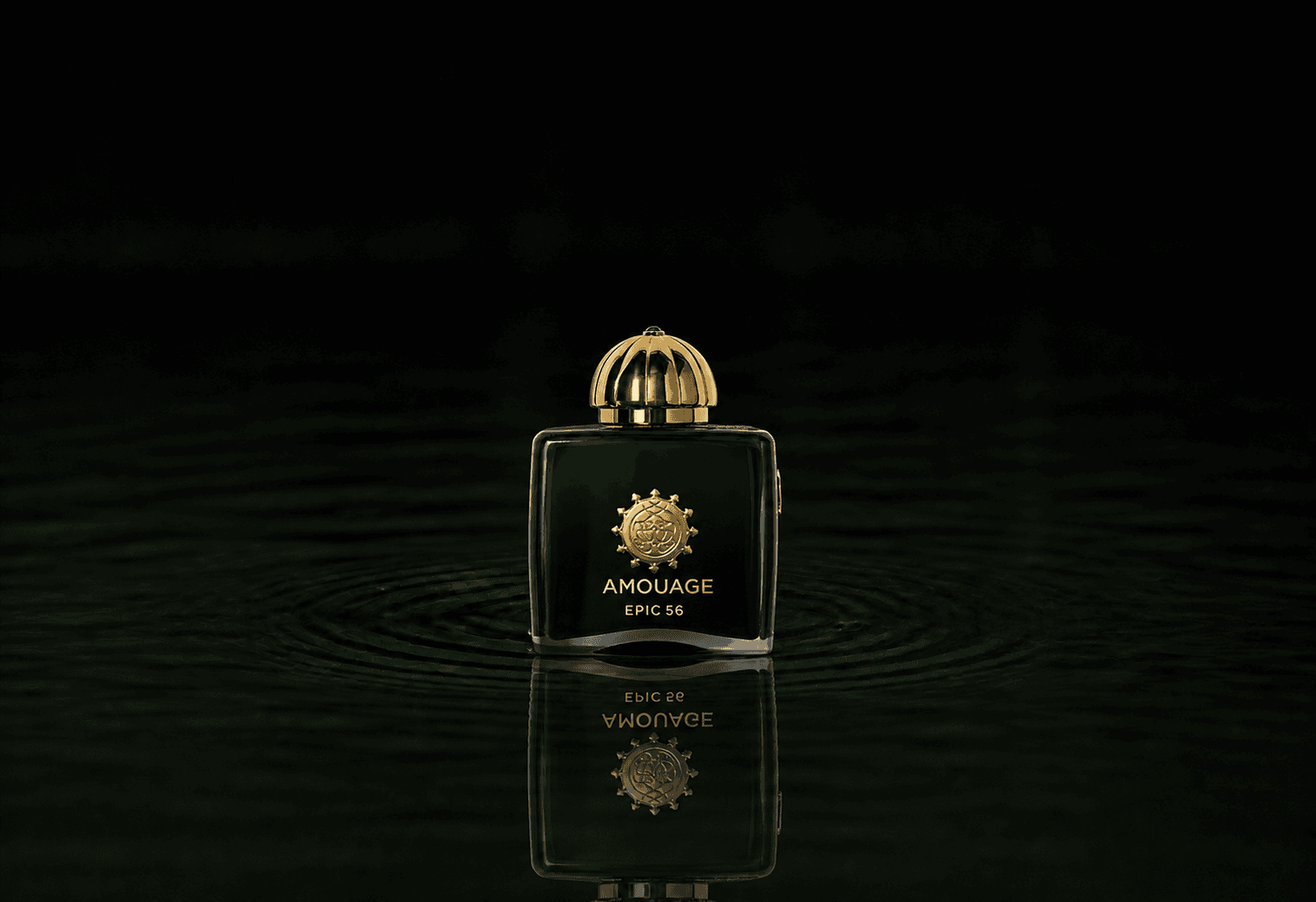 Amouage Epic Woman 56 Extrait fragrance bottle floating above dark water