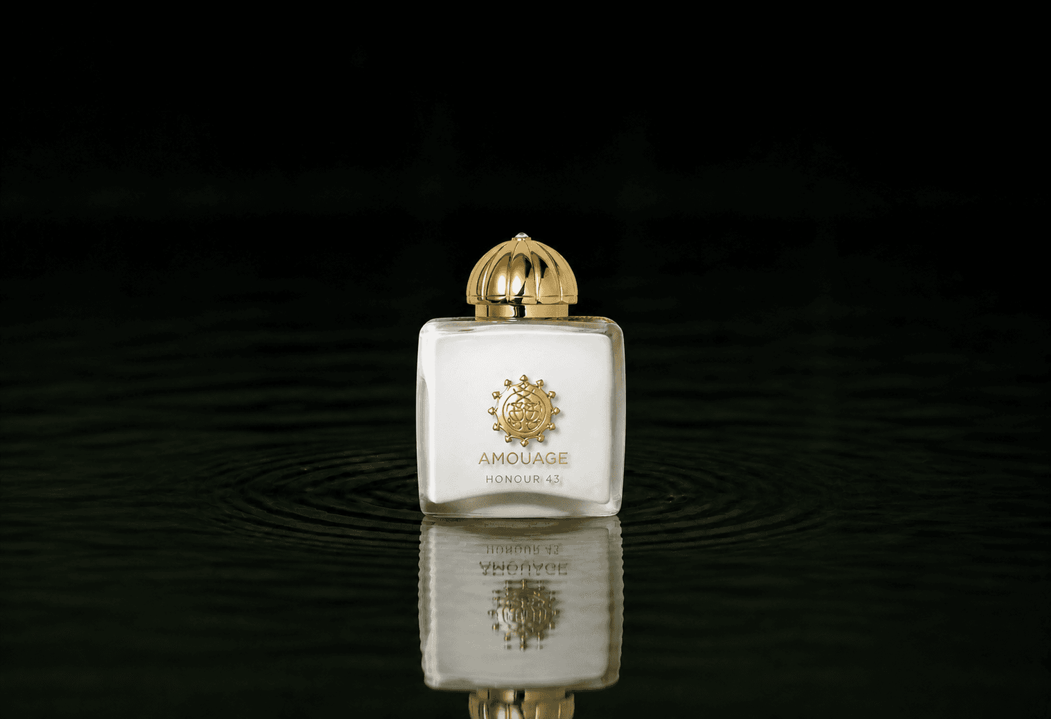 Amouage Honour Woman 43 - Extrait fragrance bottle floating above dark water