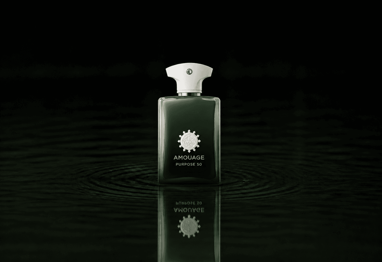 Amouage Purpose 50 fragrance bottle floating above dark water