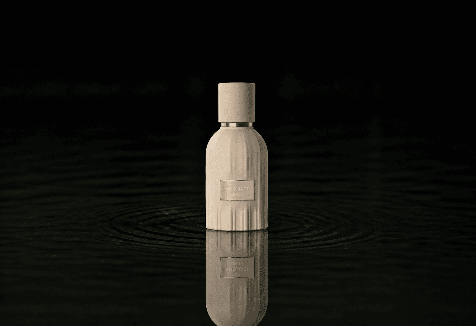 Amouage The Essences - Line 618 fragrance bottle floating above dark water