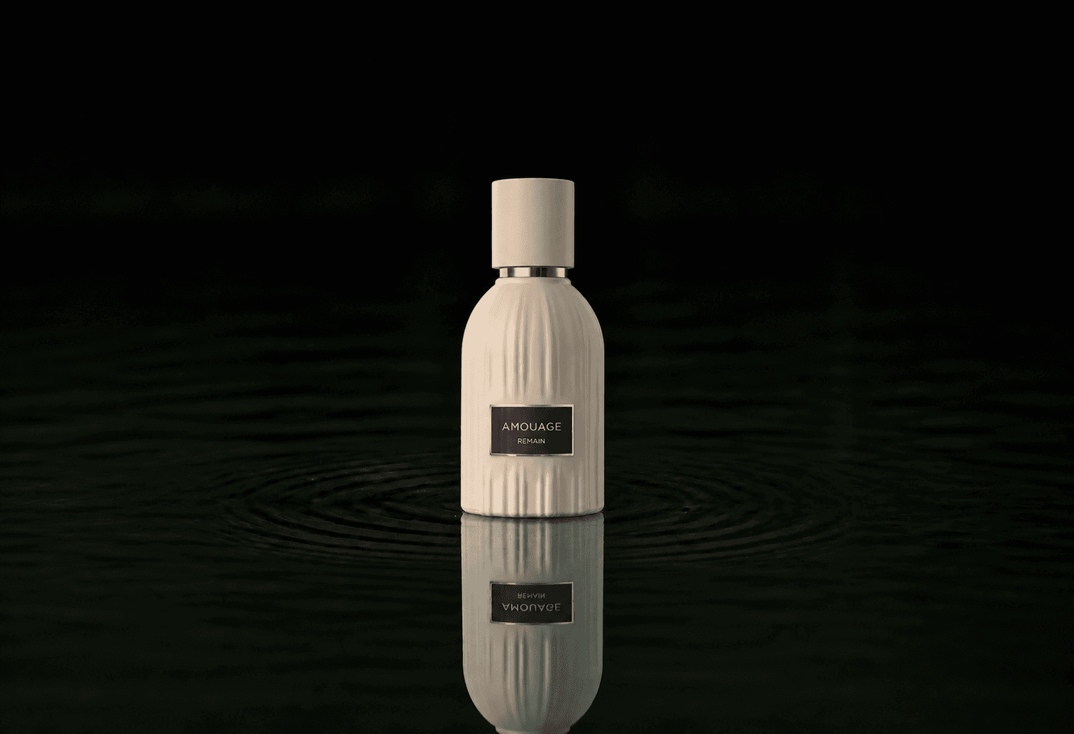 Amouage The Essences - Remain fragrance bottle floating above dark water