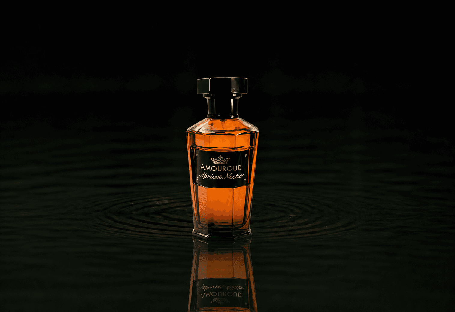 Amouroud Apricot Nectar fragrance bottle floating above dark water