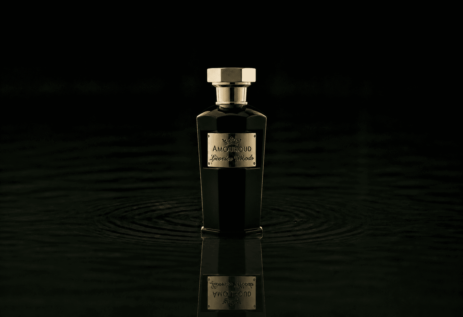 Amouroud Licorice Woods fragrance bottle floating above dark water