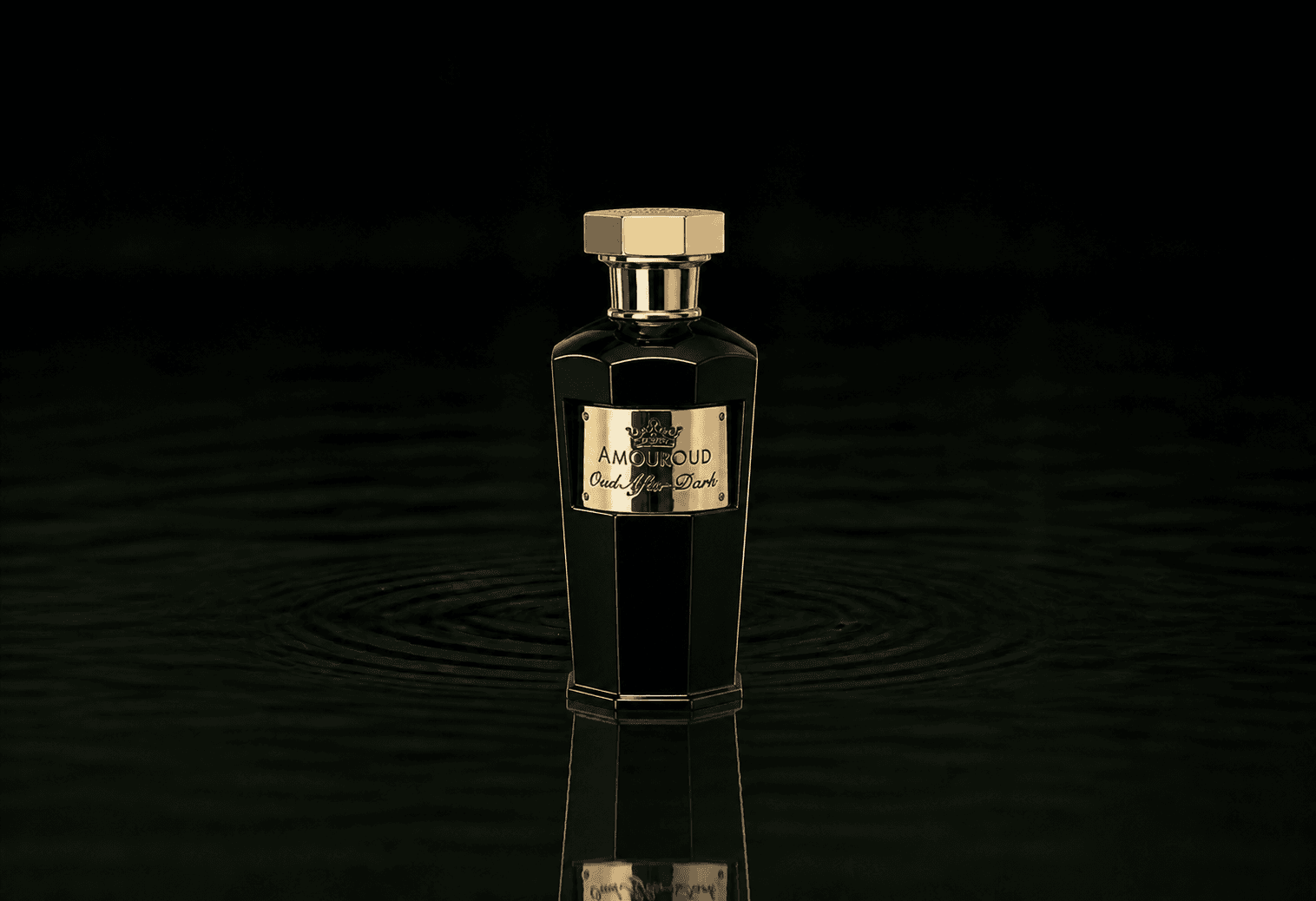 Amouroud Oud After Dark fragrance bottle floating above dark water