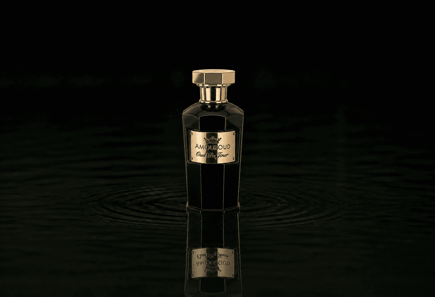 Amouroud Oud Du Jour fragrance bottle floating above dark water
