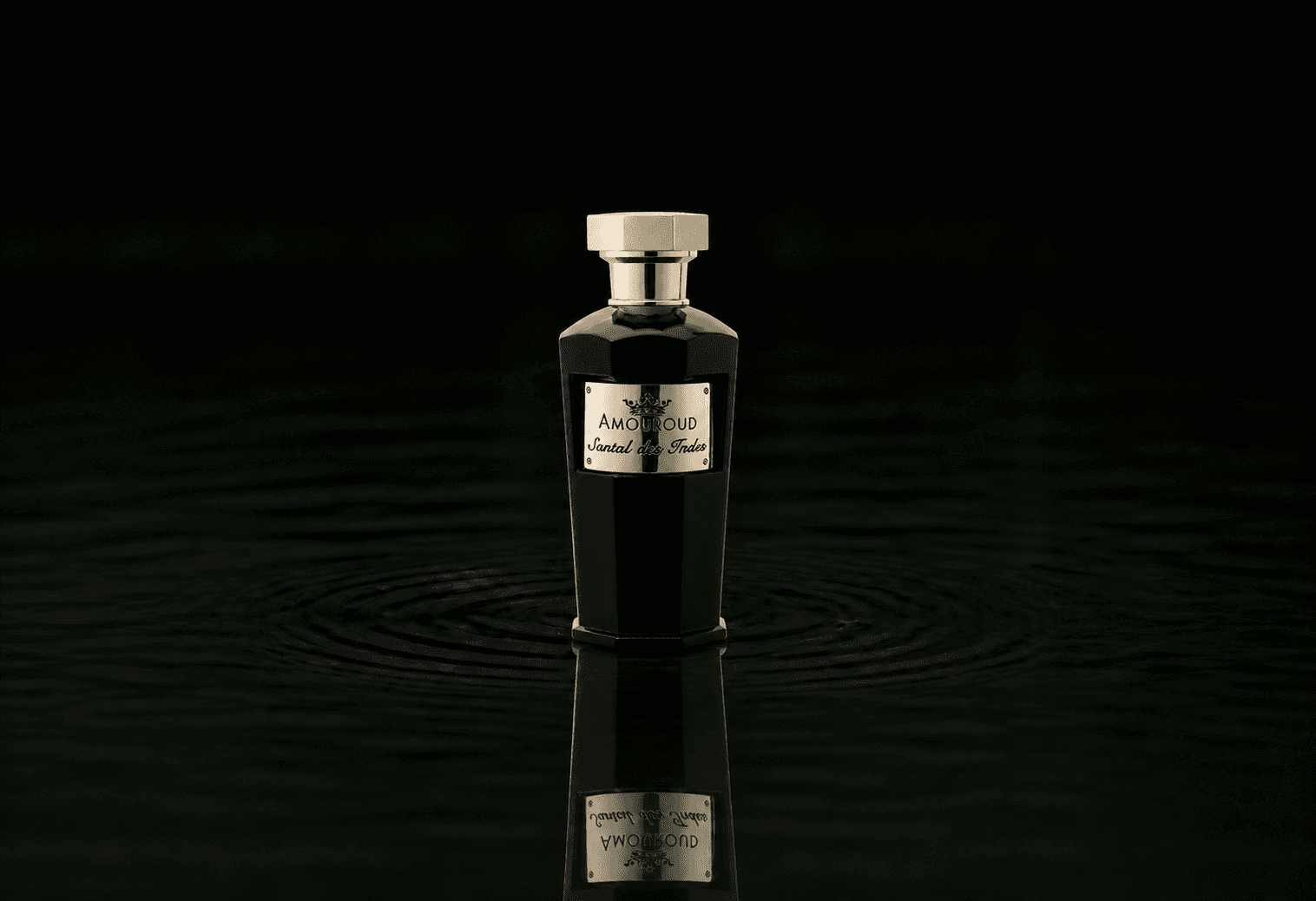 Amouroud Santal Des Indes fragrance bottle floating above dark water