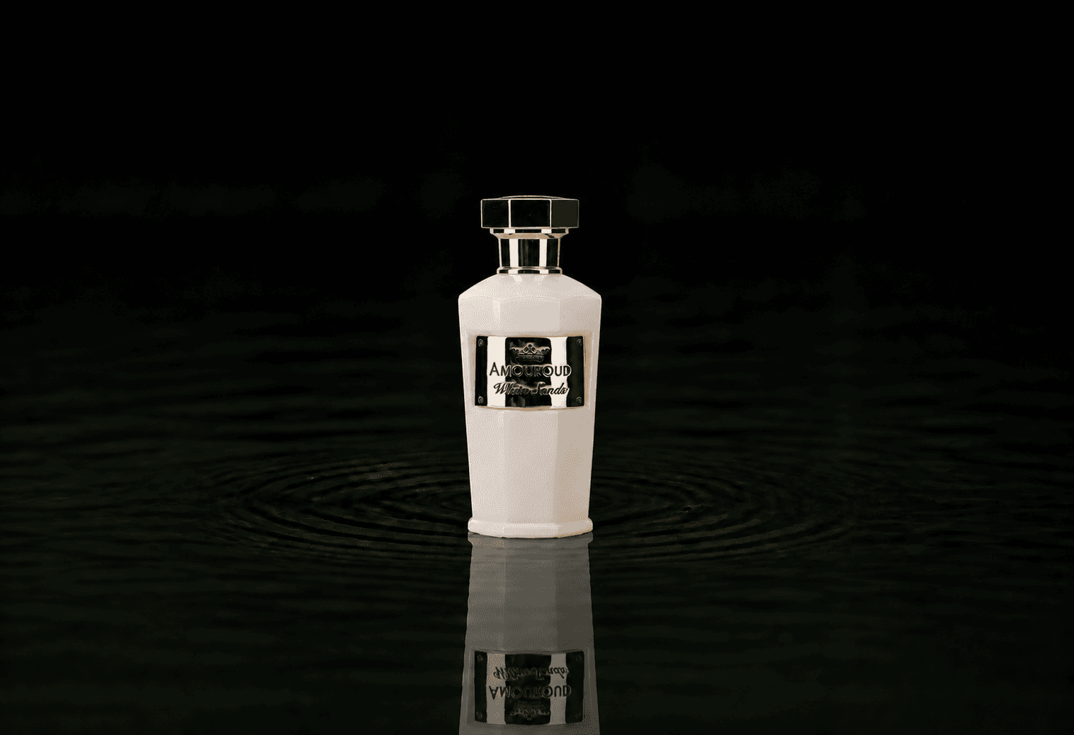 Amouroud White Sands fragrance bottle floating above dark water
