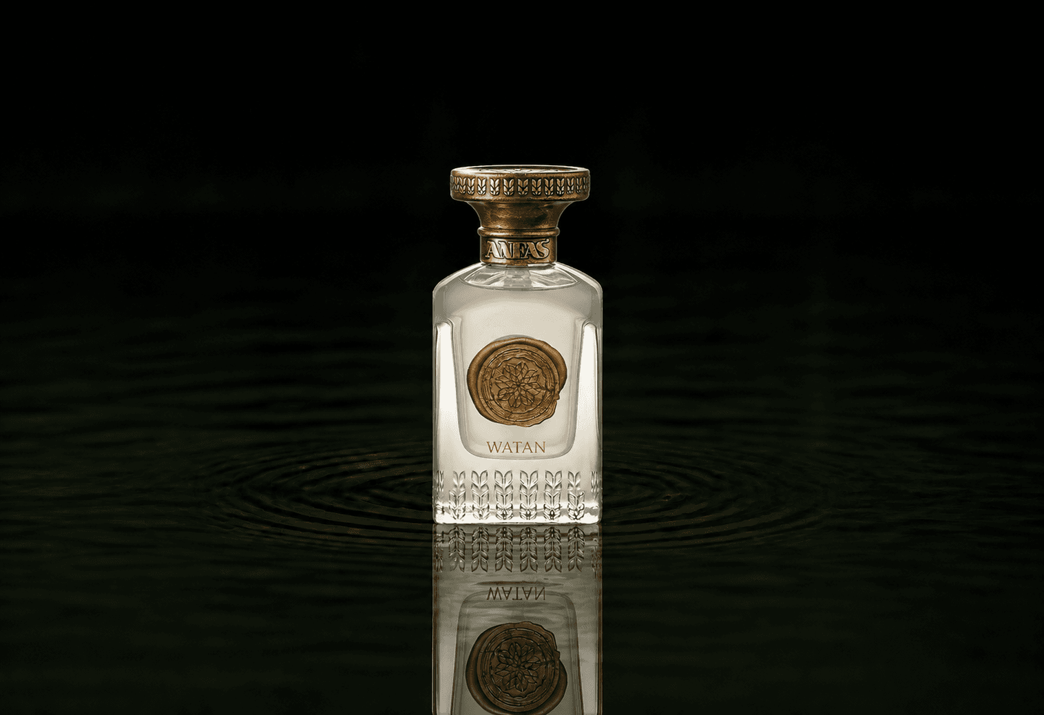 Anfas Watan fragrance bottle floating above dark water