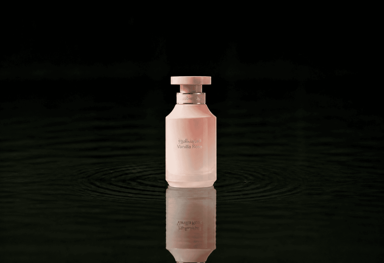 Arabian Oud Vanilla Rose fragrance bottle floating above dark water