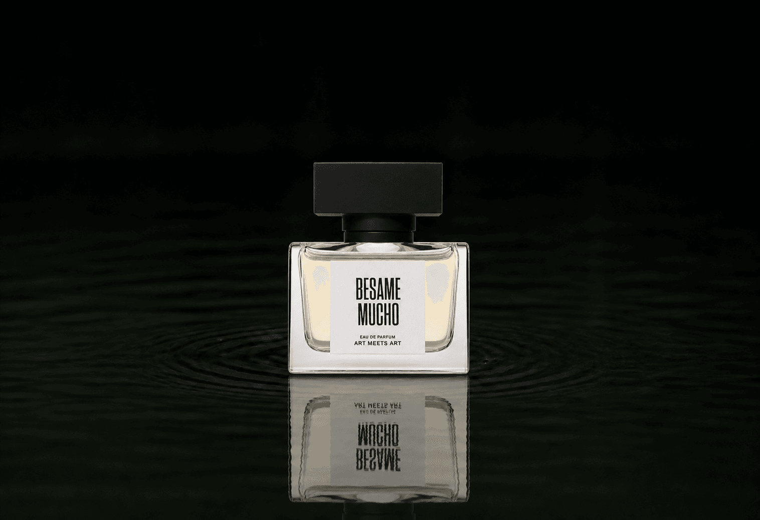 Art Meets Art Besame Mucho fragrance bottle floating above dark water