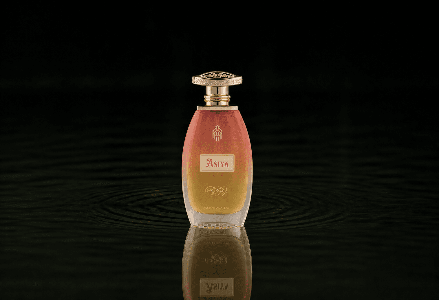Asghar Adam Ali Asiya fragrance bottle floating above dark water