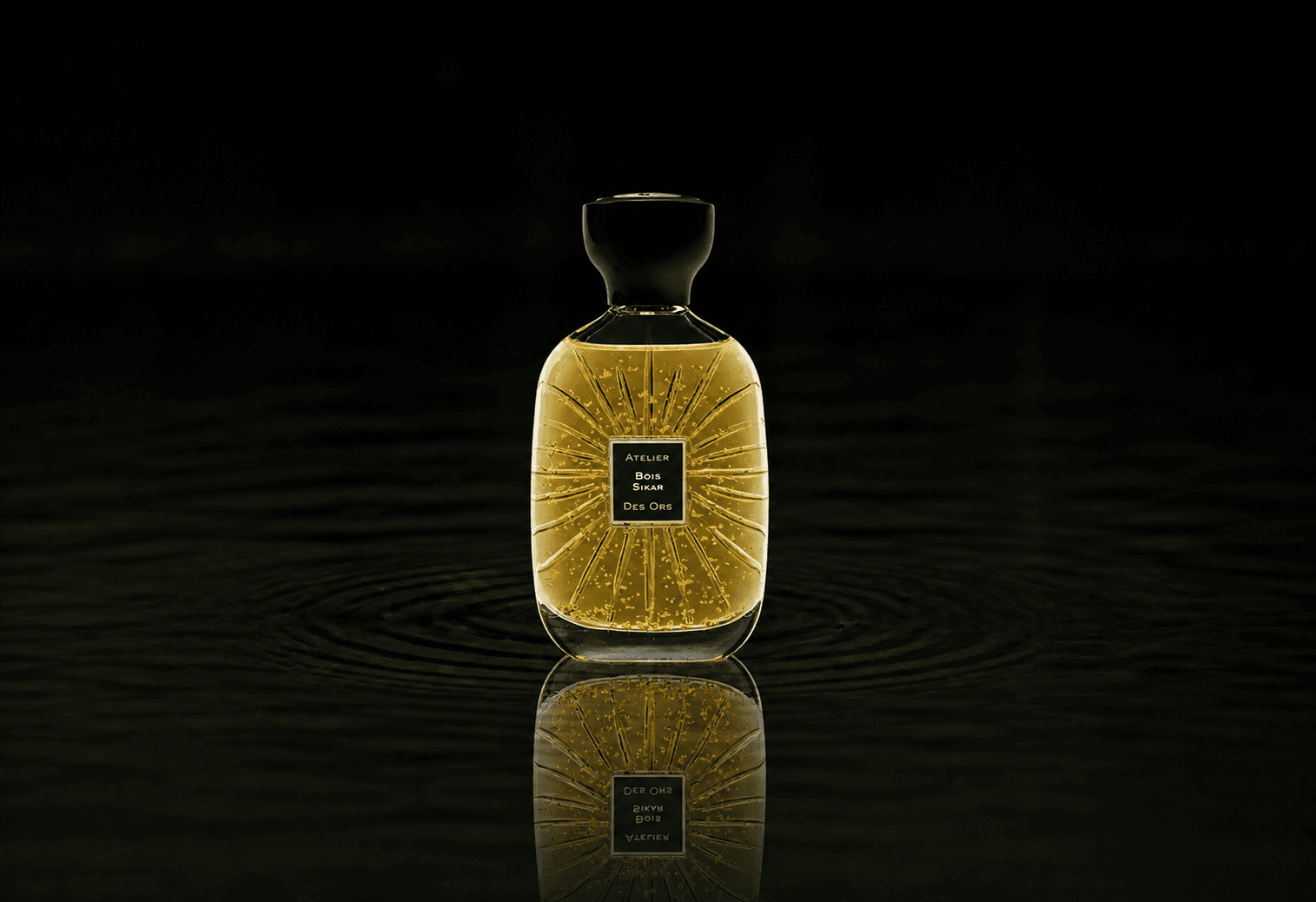 Atelier Des Ors Atelier Des Ors - Black Collection - Bois Sikar fragrance bottle floating above dark water