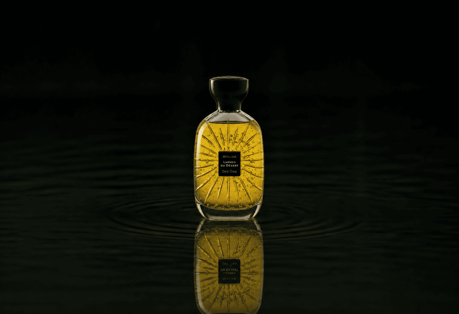 Atelier Des Ors Atelier Des Ors - Black Collection - Larmes du Désert fragrance bottle floating above dark water