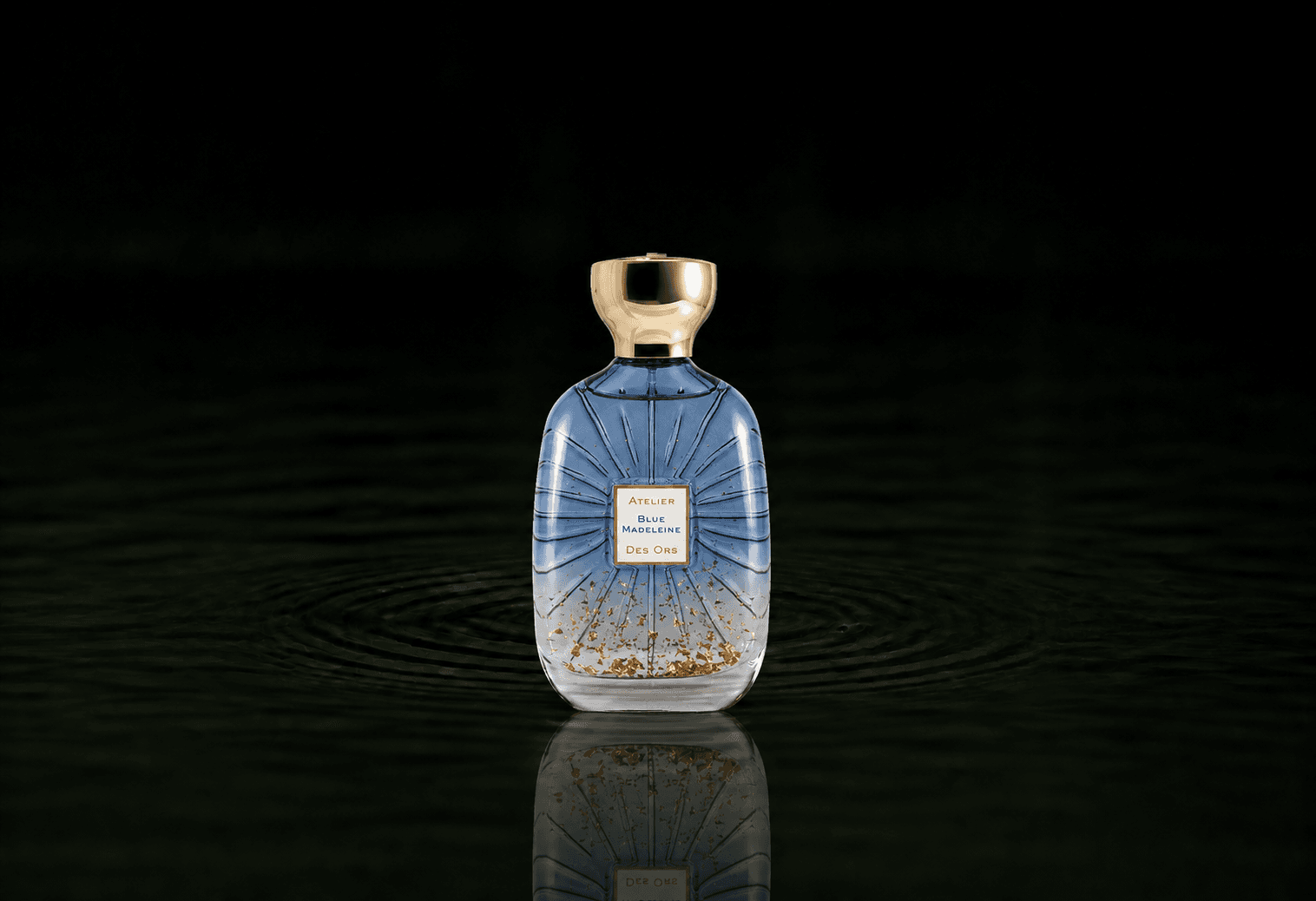 Atelier Des Ors Blue Madeleine fragrance bottle floating above dark water