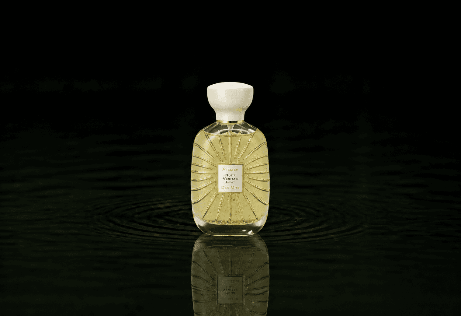 Atelier Des Ors Nuda Veritas Extrait fragrance bottle floating above dark water