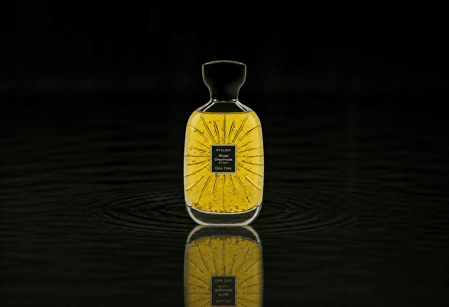 Atelier Des Ors Rose Omeyyade Extrait fragrance bottle floating above dark water