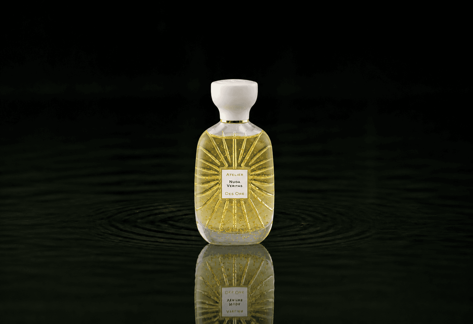 Atelier Des Ors White Collection - Nuda Veritas fragrance bottle floating above dark water