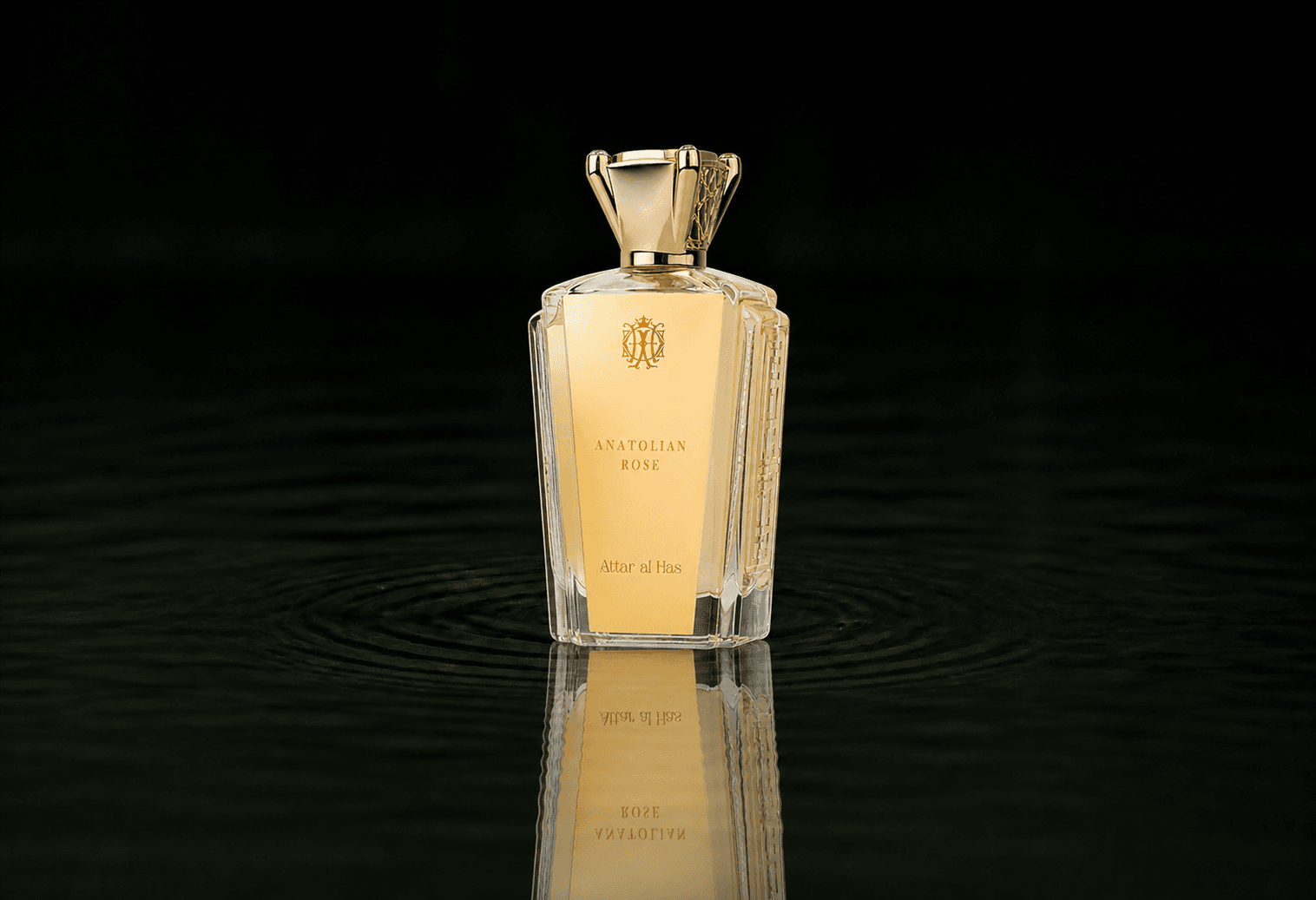 Attar Al Has Anatolian Rose fragrance bottle floating above dark water