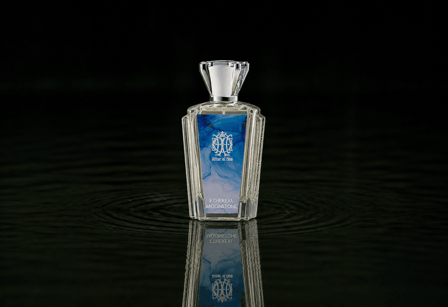 Attar Al Has Ethereal Moonstone fragrance bottle floating above dark water