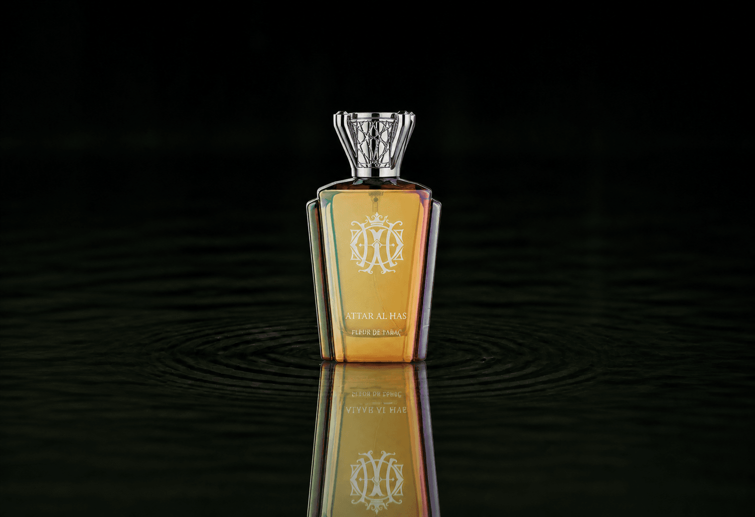 Attar Al Has Fleur De Tabac fragrance bottle floating above dark water
