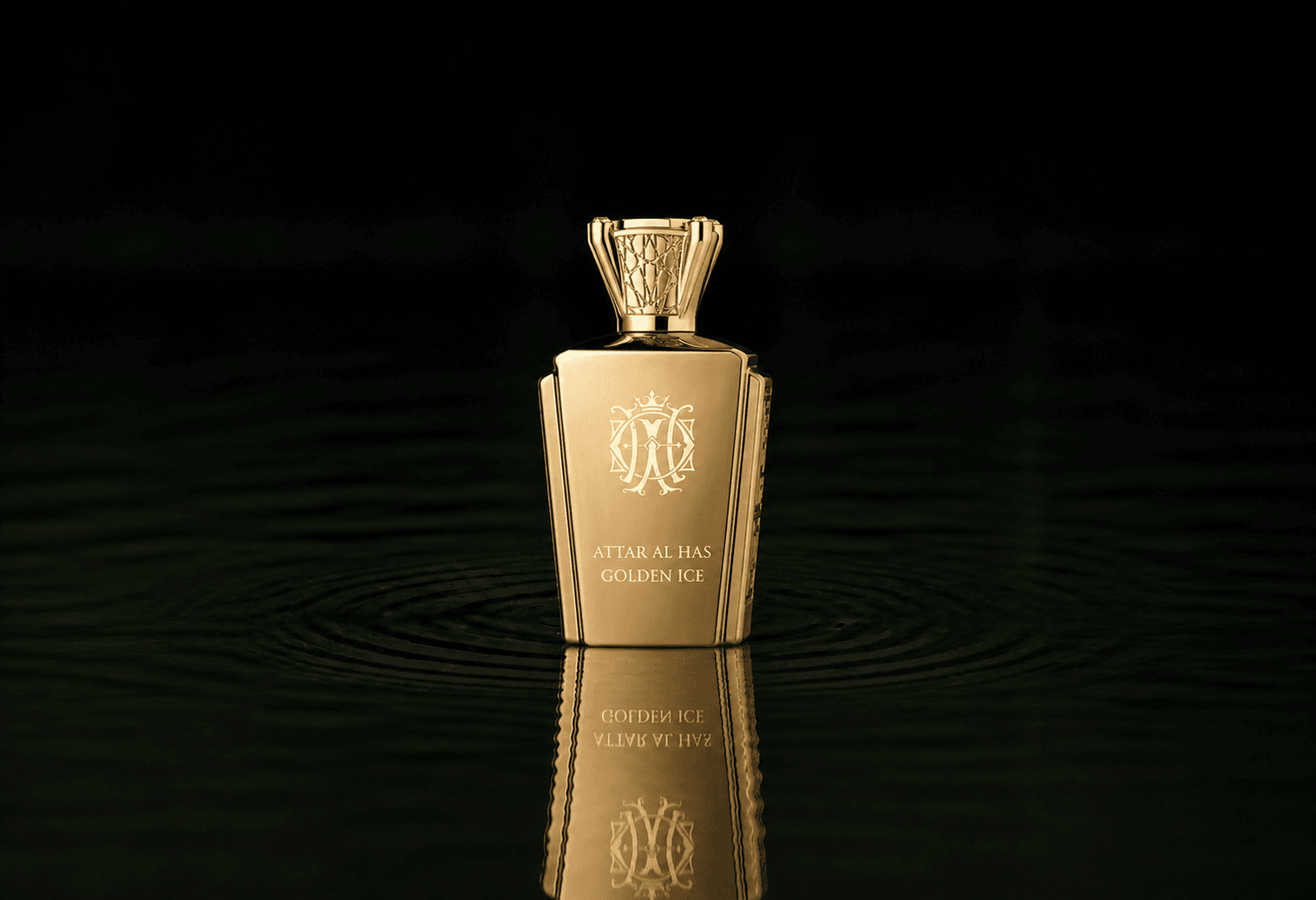 Attar Al Has Golden Ice fragrance bottle floating above dark water
