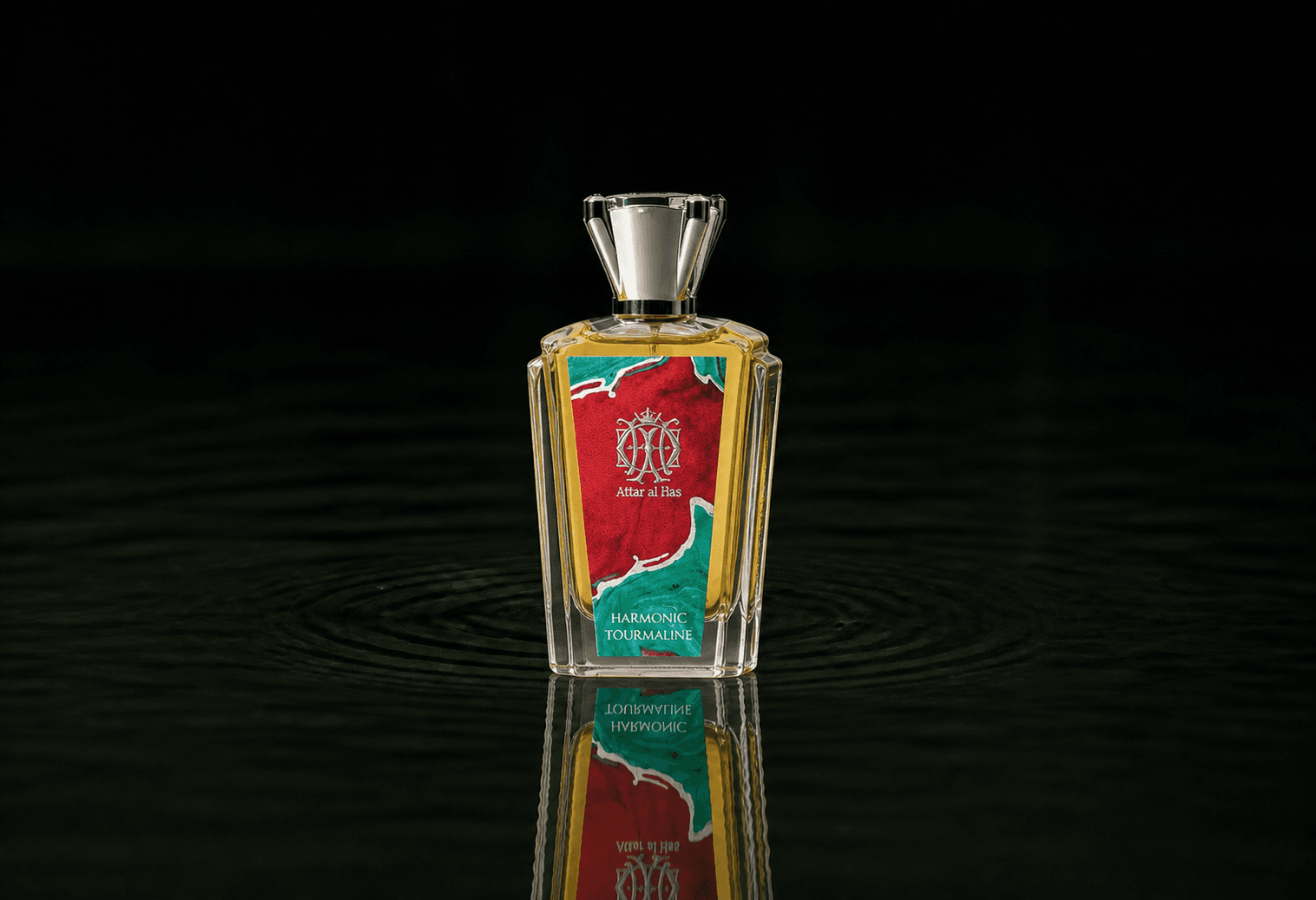 Attar Al Has Harmonic Tourmaline fragrance bottle floating above dark water