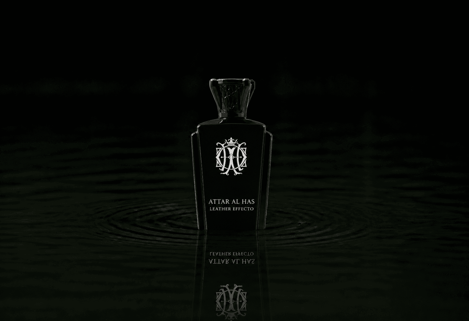 Attar Al Has Leather Effecto fragrance bottle floating above dark water