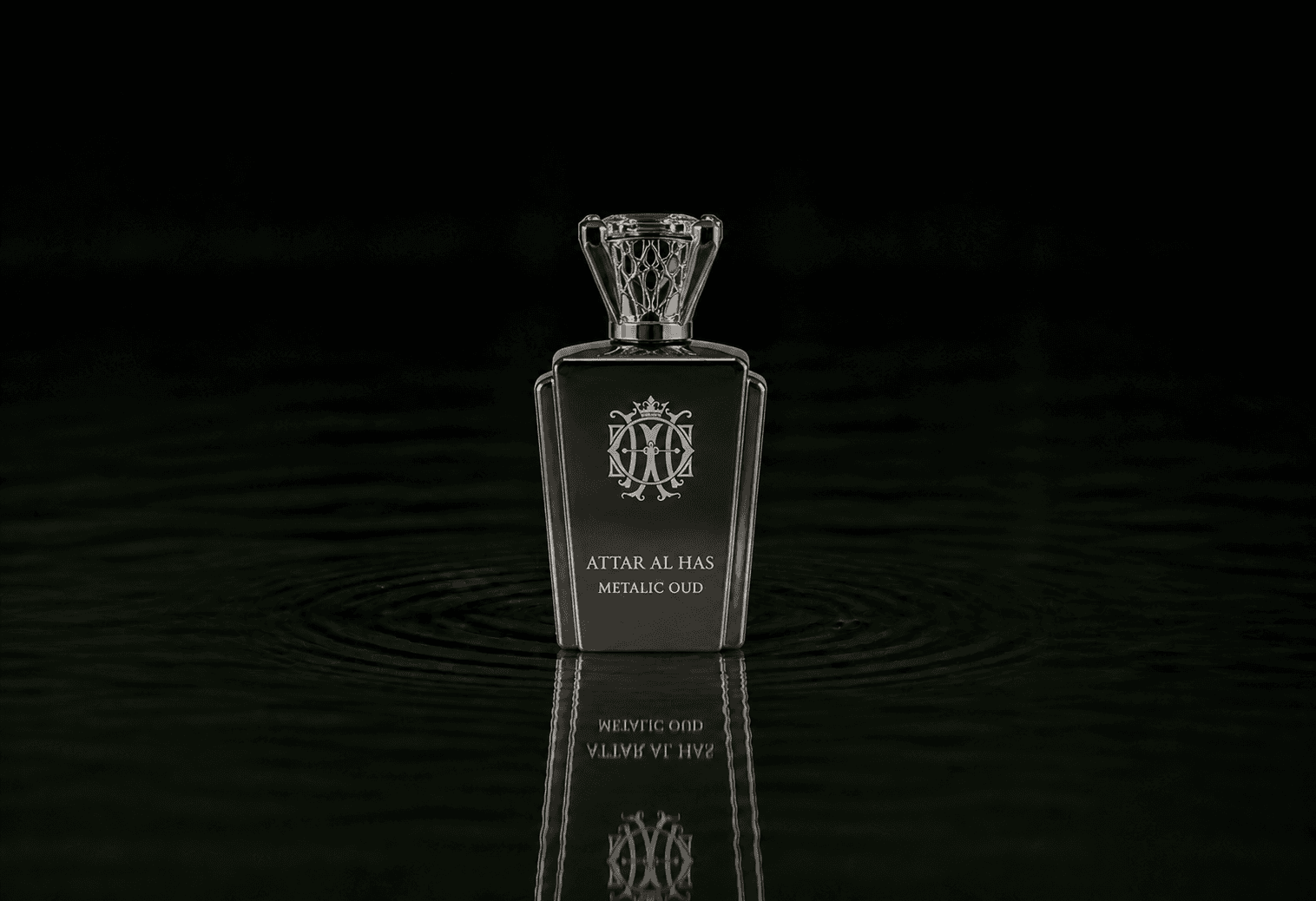 Attar Al Has Metalic Oud fragrance bottle floating above dark water