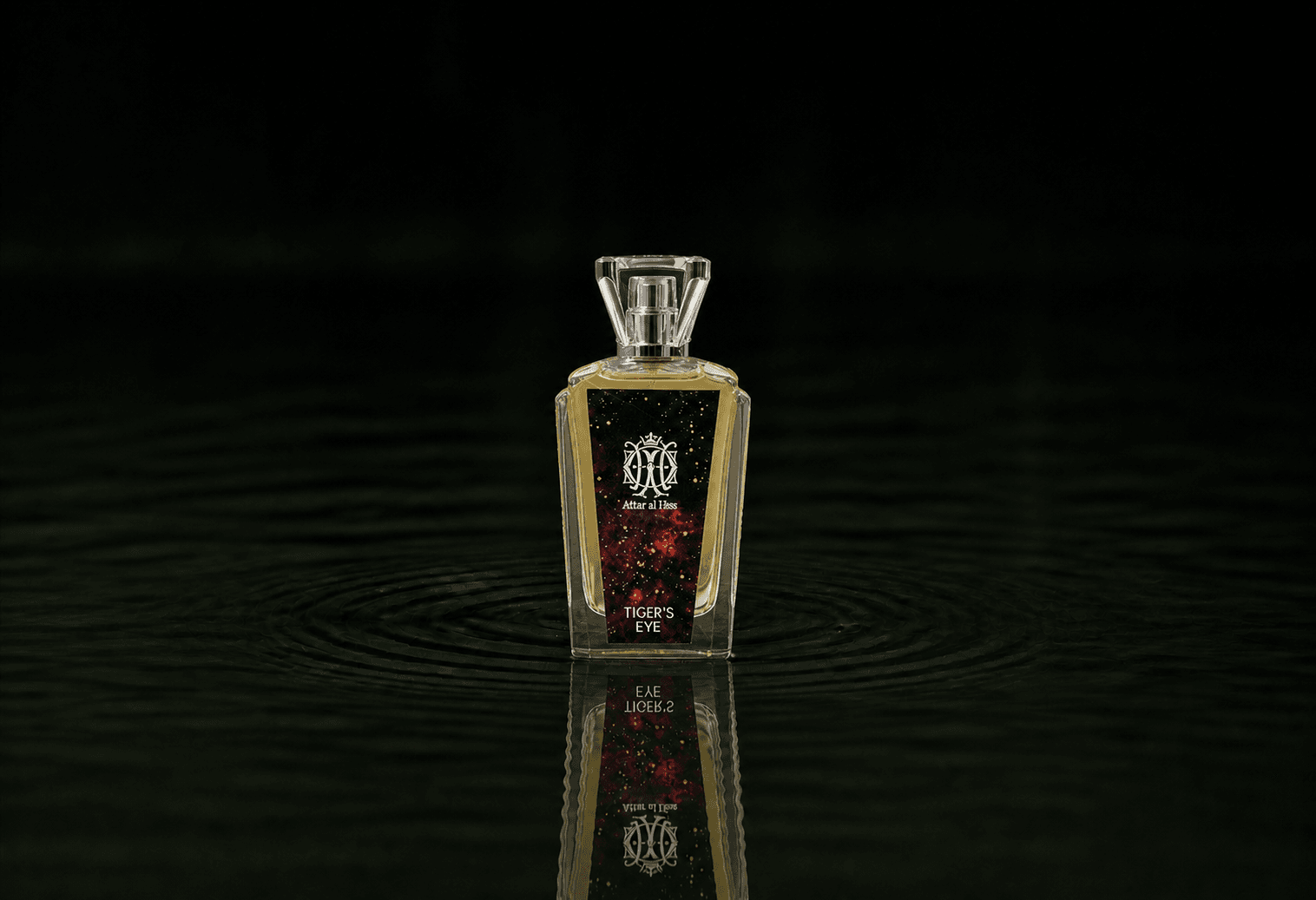 Attar Al Has Tiger's Eye fragrance bottle floating above dark water