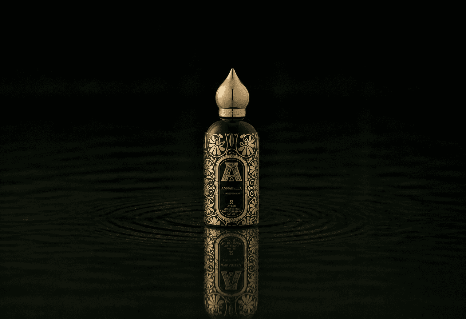 Attar Collection Attar - Collection Annabella fragrance bottle floating above dark water