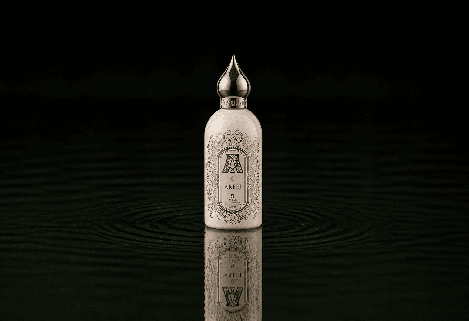Attar Collection Attar - Collection Areej fragrance bottle floating above dark water