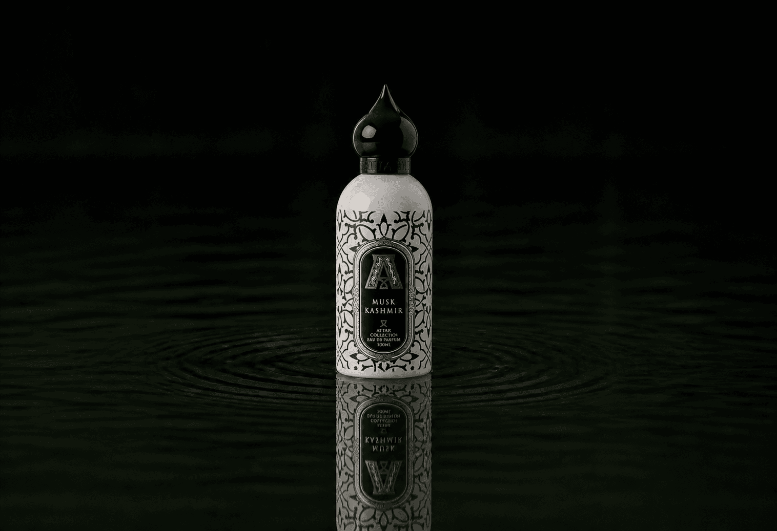 Attar Collection Attar - Musk Kashmir fragrance bottle floating above dark water