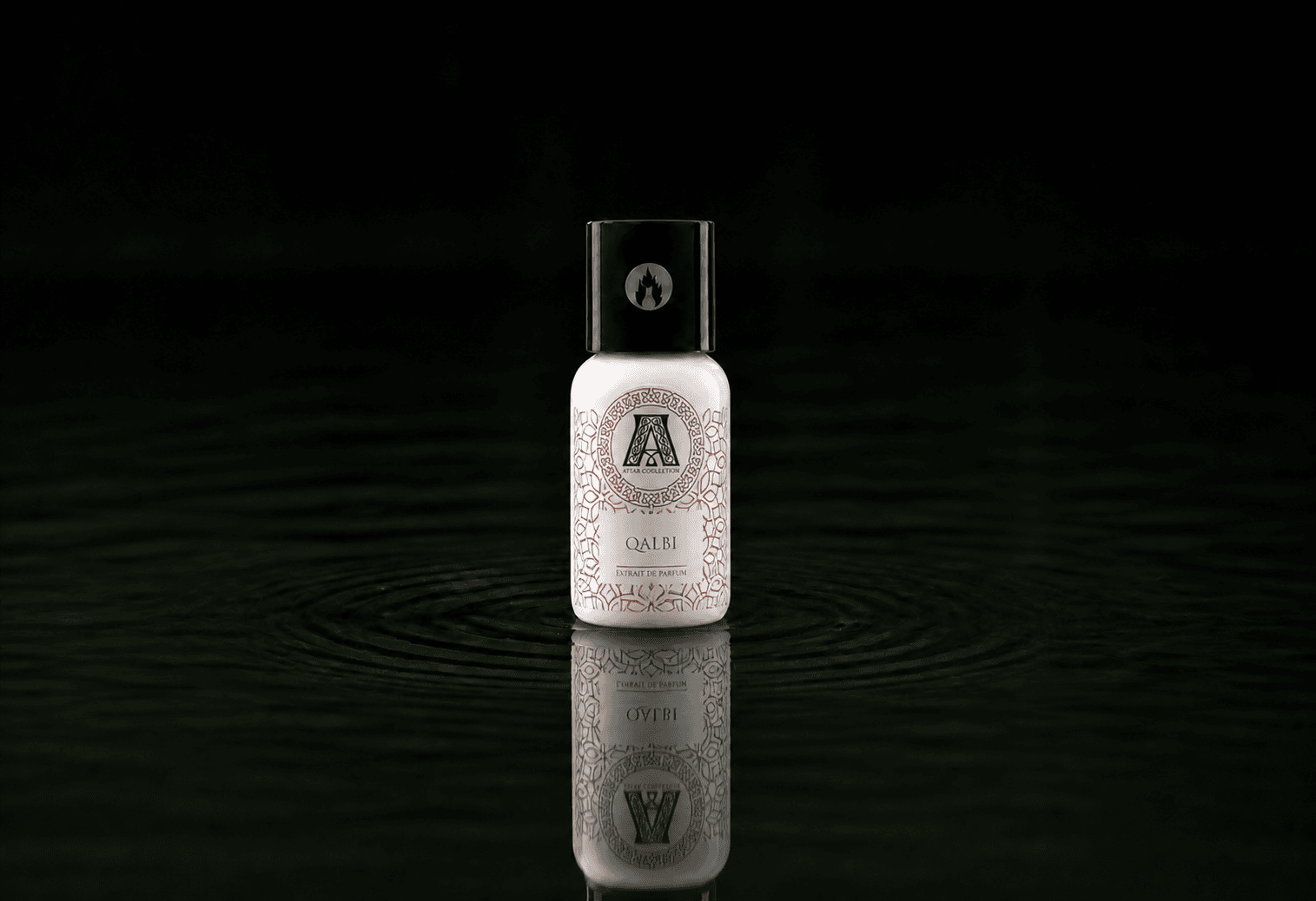 Attar Collection Attar - Qalbi fragrance bottle floating above dark water