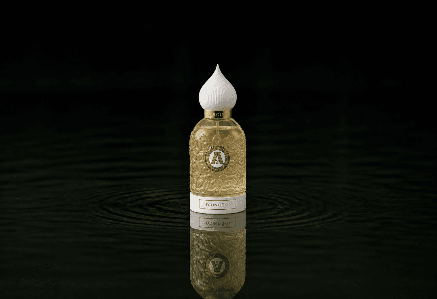Attar Collection Attar - Second Skin fragrance bottle floating above dark water
