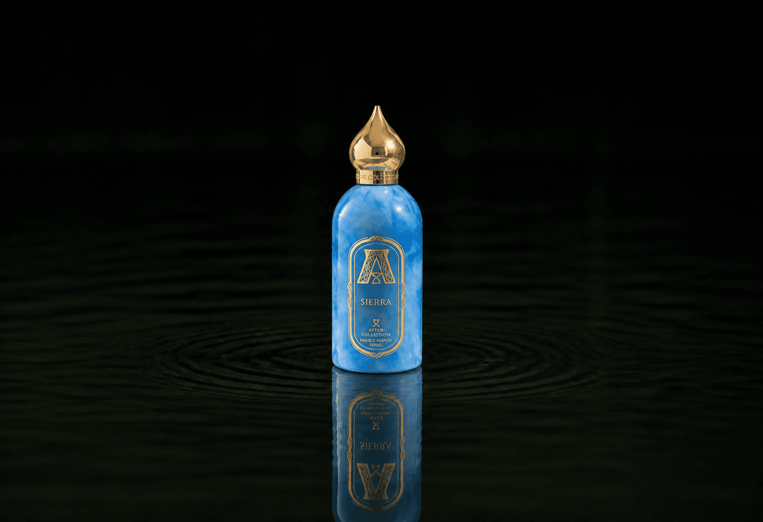 Attar Collection Attar - Sierra fragrance bottle floating above dark water
