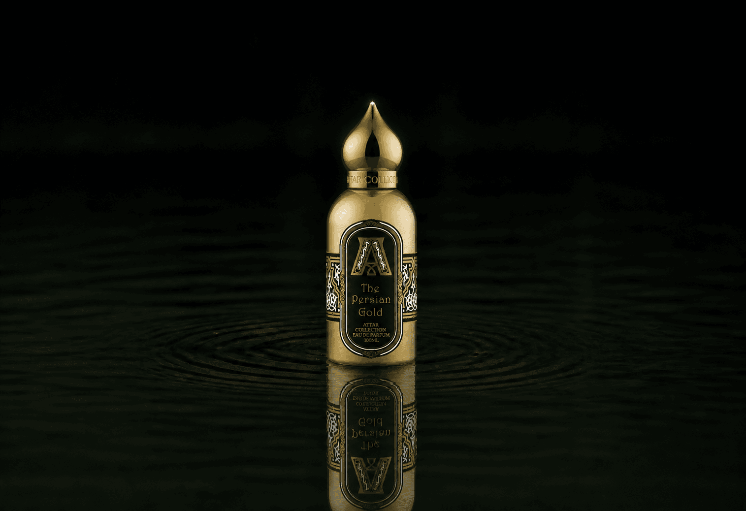 Attar Collection The Persian Gold fragrance bottle floating above dark water