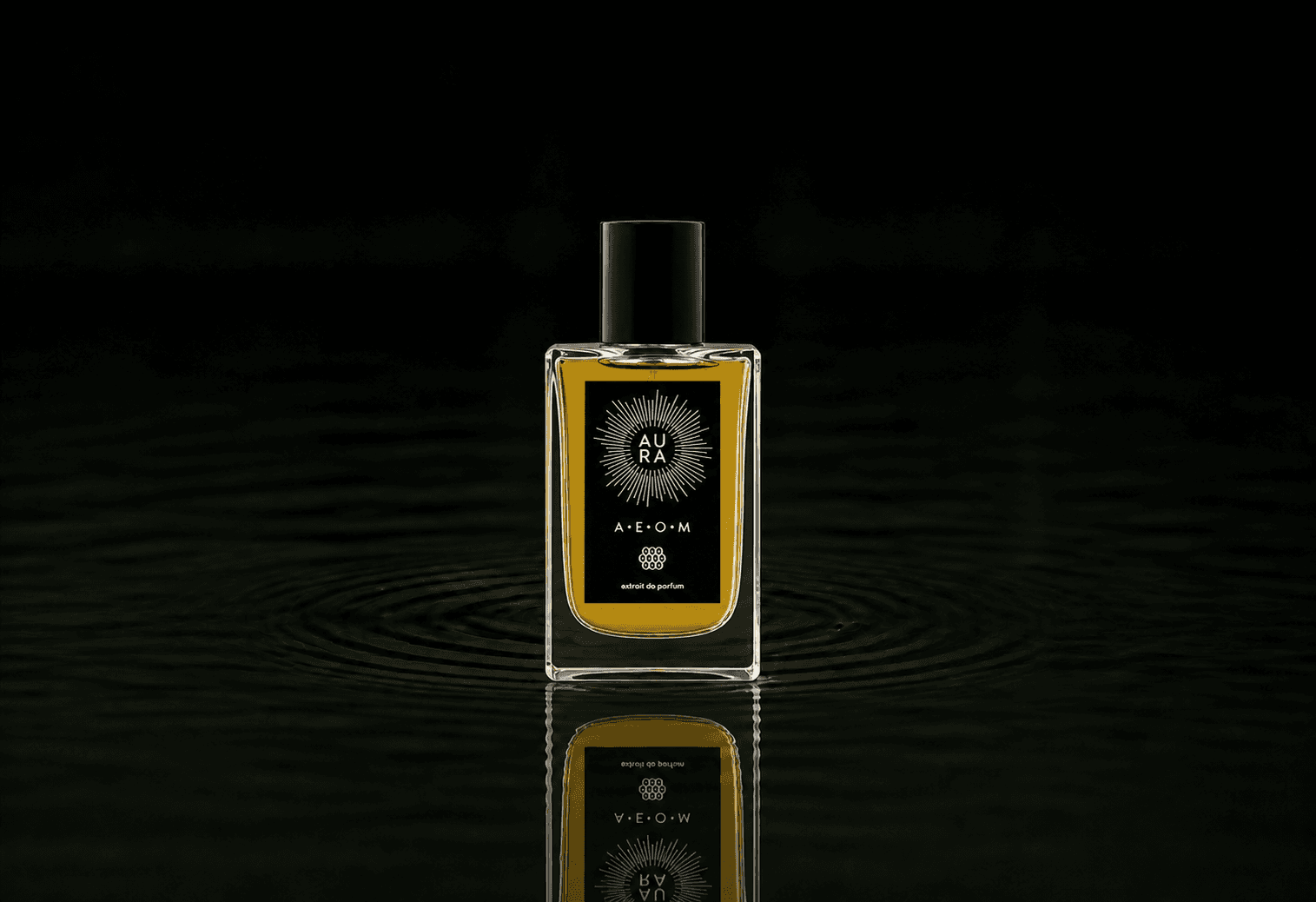 Aura Perfumes Aura Perfume - A.E.O.M. fragrance bottle floating above dark water